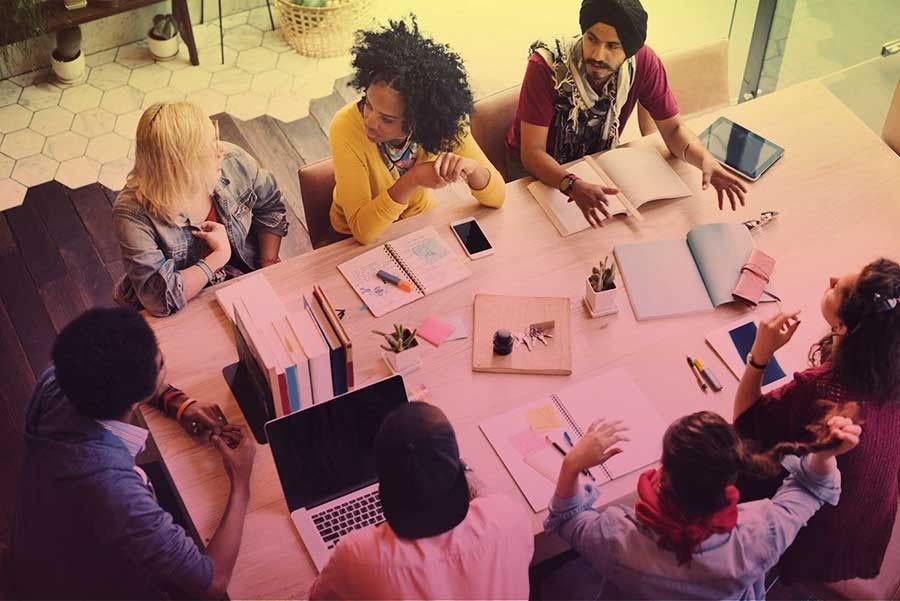 A group of people in discussion sitting at a table.